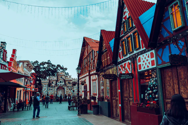 Joyful travelers exploring a charming European village with cobblestone streets and historic buildings.