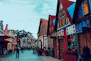 A couple exploring a charming European city street with historic buildings.
