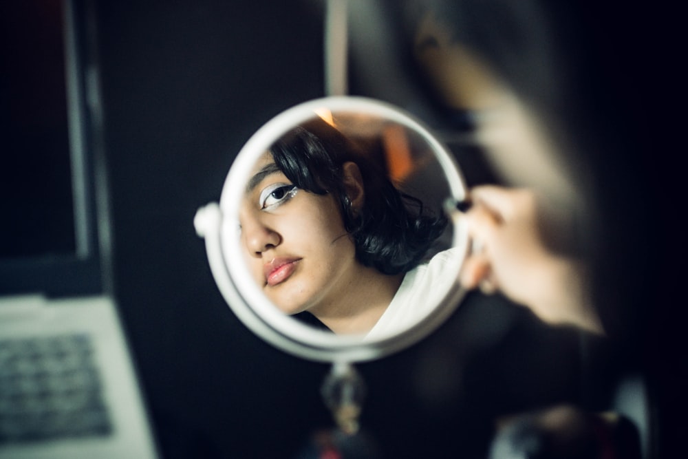 a woman looking through a magnifying glass