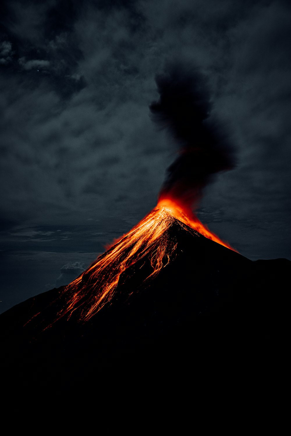 a volcano erupting at night