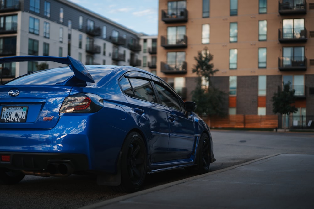 a blue car parked on the side of a road