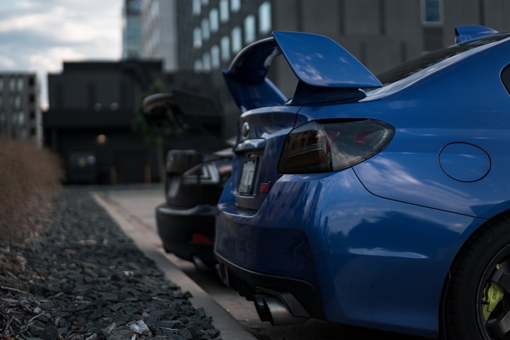 a blue car parked on a street