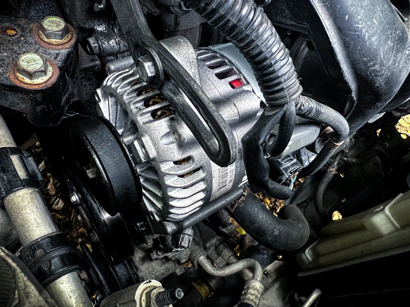 Close-up of a car engine and alternator during a diagnostic check