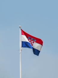 a couple of flags on a pole