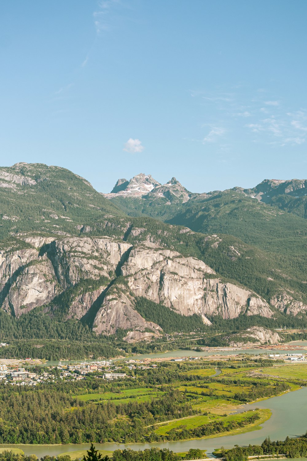 a large mountain with a town below