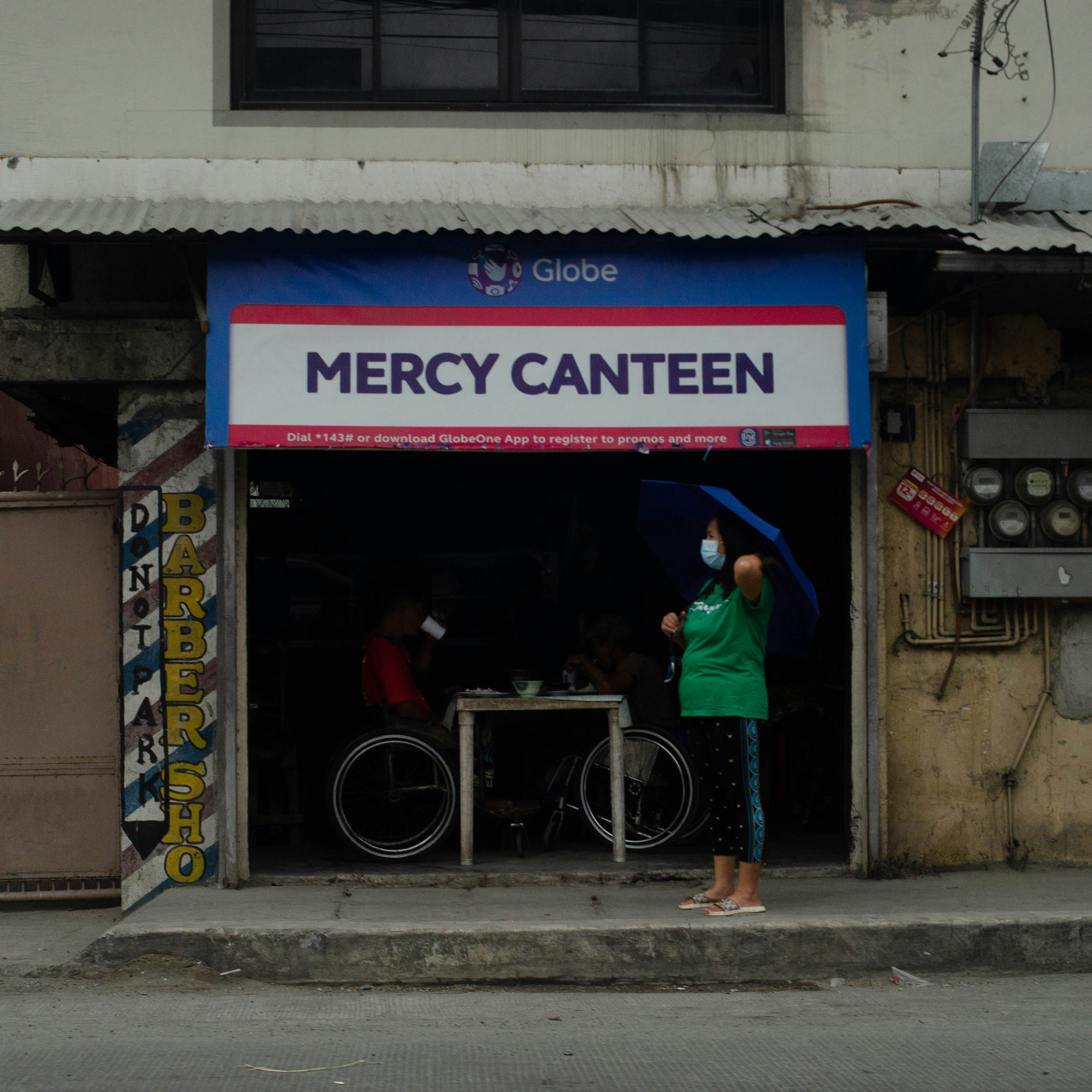 A person standing in front of a storefront photo – Free Street Image on ...