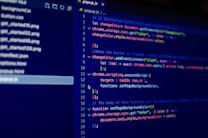 The image displays a computer screen with a code editor open. The code editor contains a JavaScript file named popup.js. Lines of code are written with various syntax coloring, typical for JavaScript. On the left side of the screen, there is a file explorer showing a list of files and directories.