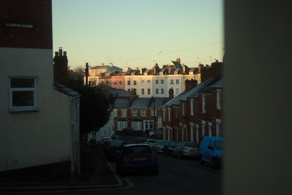 a street of Exeter HMO's with cars parked along it