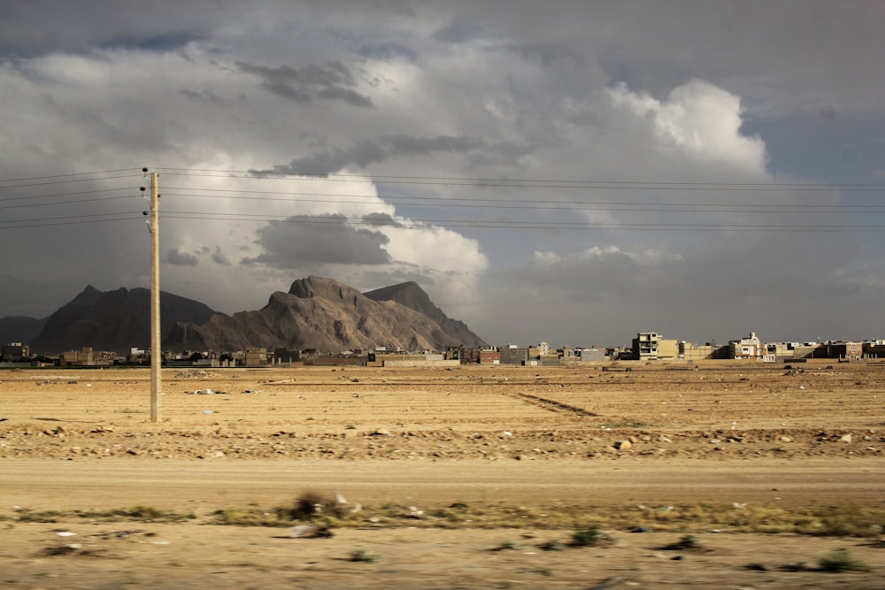 a landscape with a mountain in the background