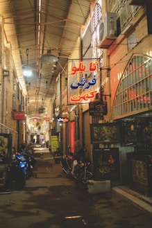 a street in Tehran with signs and scooters in Farsi