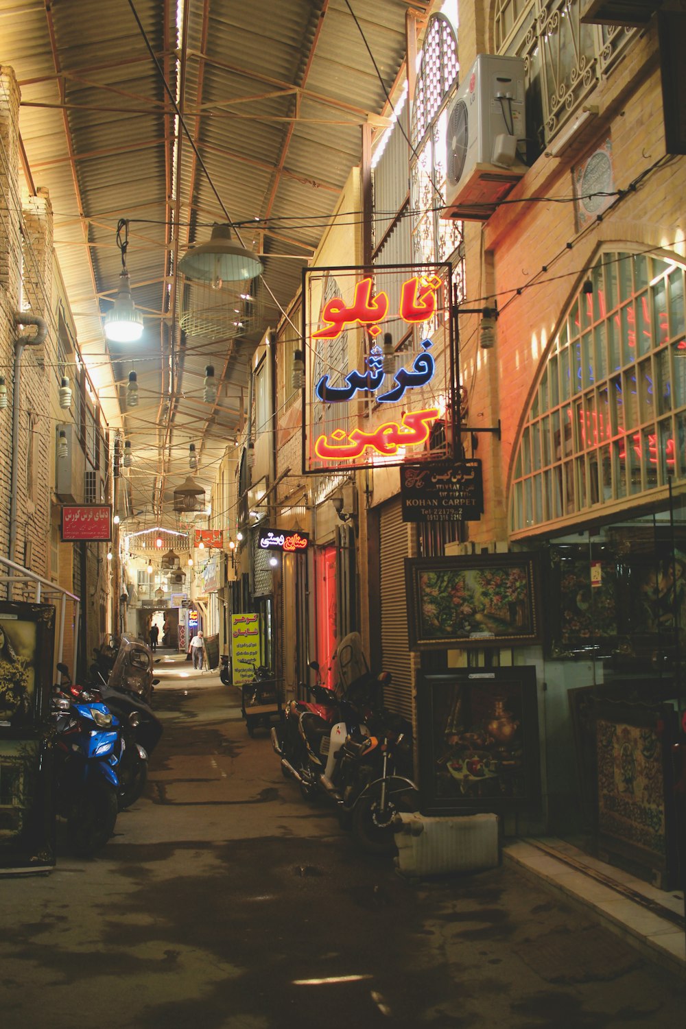 a street with signs and scooters