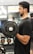 A woman lifting weights with a focused expression.