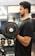 A close-up of a person lifting weights in a gym setting.
