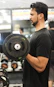 Athlete lifting weights in a modern gym with focused determination.