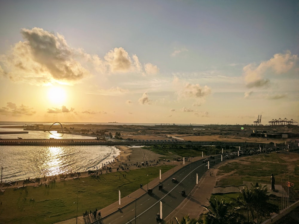 a road with cars on it next to a body of water