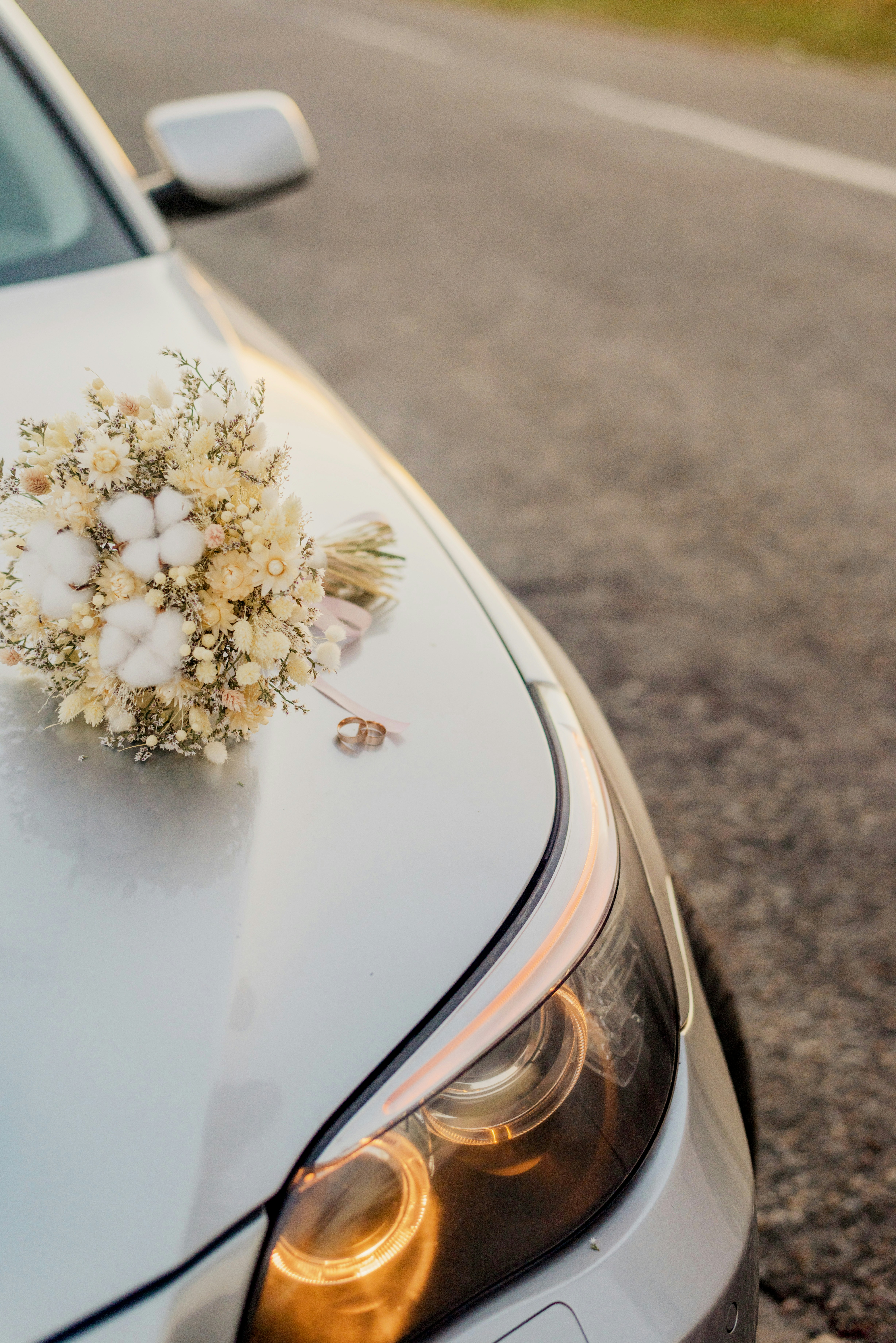 a white car with flowers on the hood
