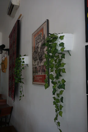 A poster with an artistic print hanging on a cozy living room wall.