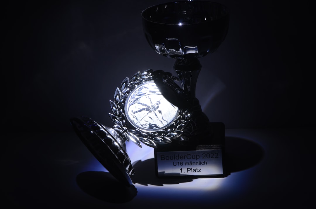 A gleaming crystal trophy stands on a display, symbolizing achievement and recognition - award sayings appreciation A gleaming crystal trophy stands on a display, symbolizing achievement and recognition - award sayings appreciation