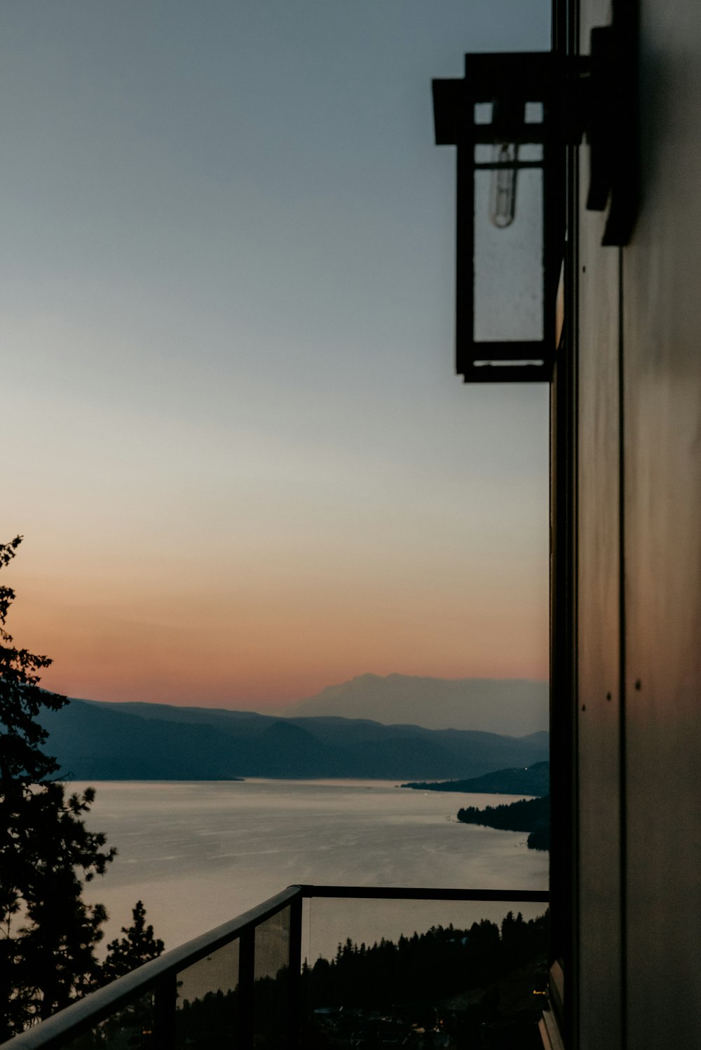 a view of a lake and mountains from a window