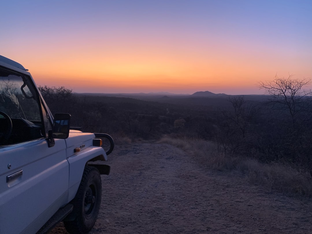 a car parked on a dirt road, Bushveld Sunset in Balule