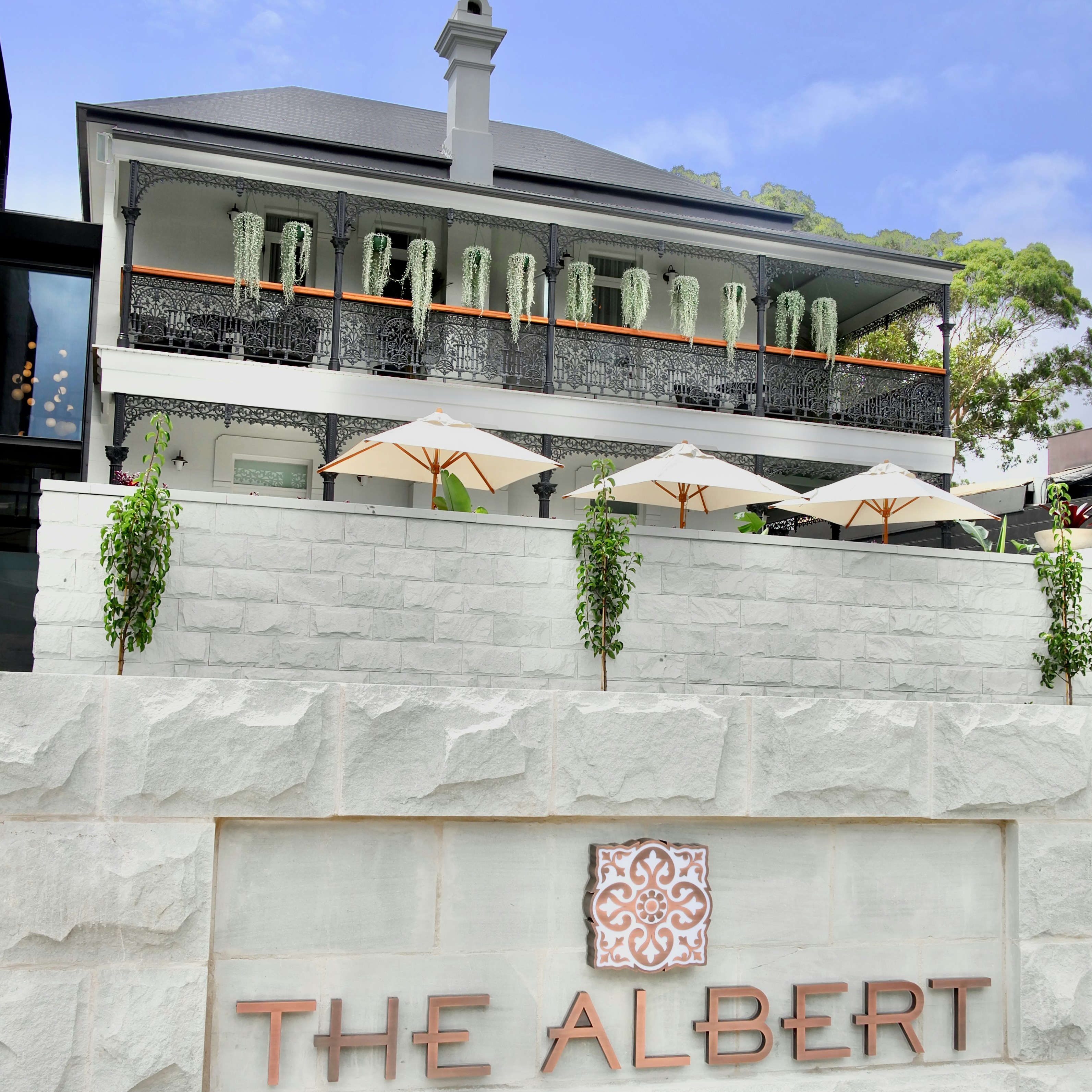 a building with umbrellas and plants