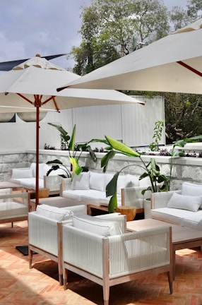 a white lounge chair and umbrella