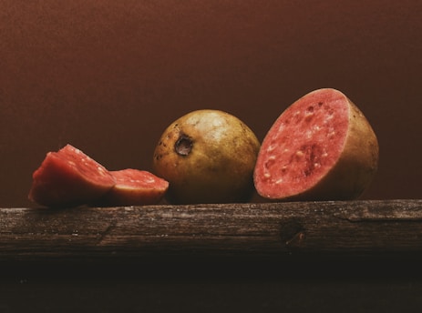 Close-up of fresh local Ngangu fruits arranged on a rustic wooden table.