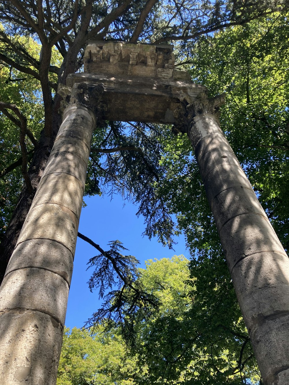 a stone structure with trees around it