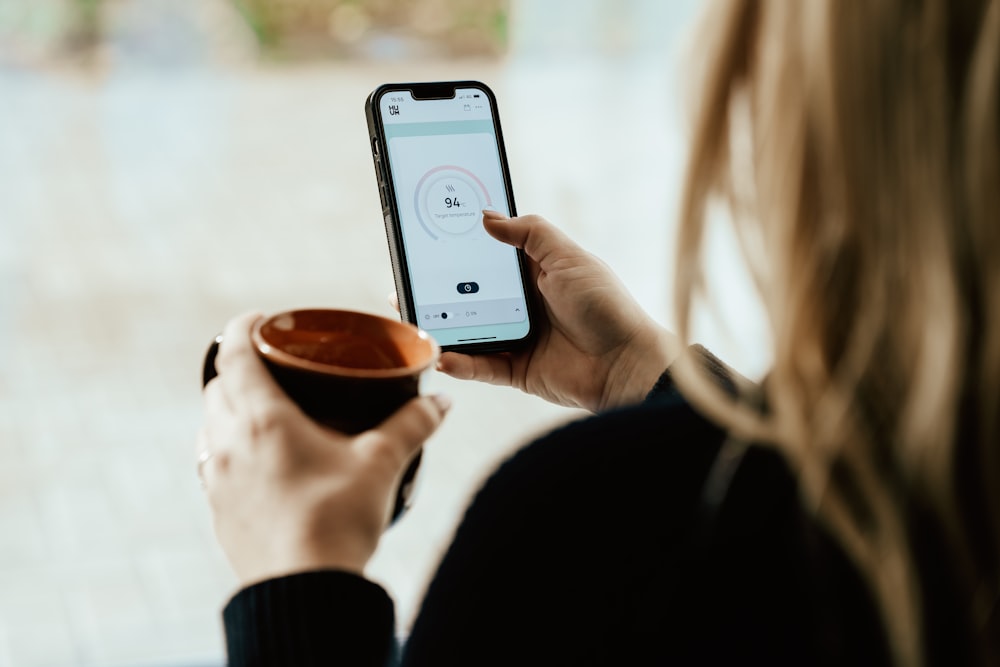 a person holding a cup of coffee