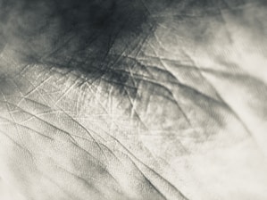 Close-up of textured materials and architectural sketches highlighting the tactile nature of design.