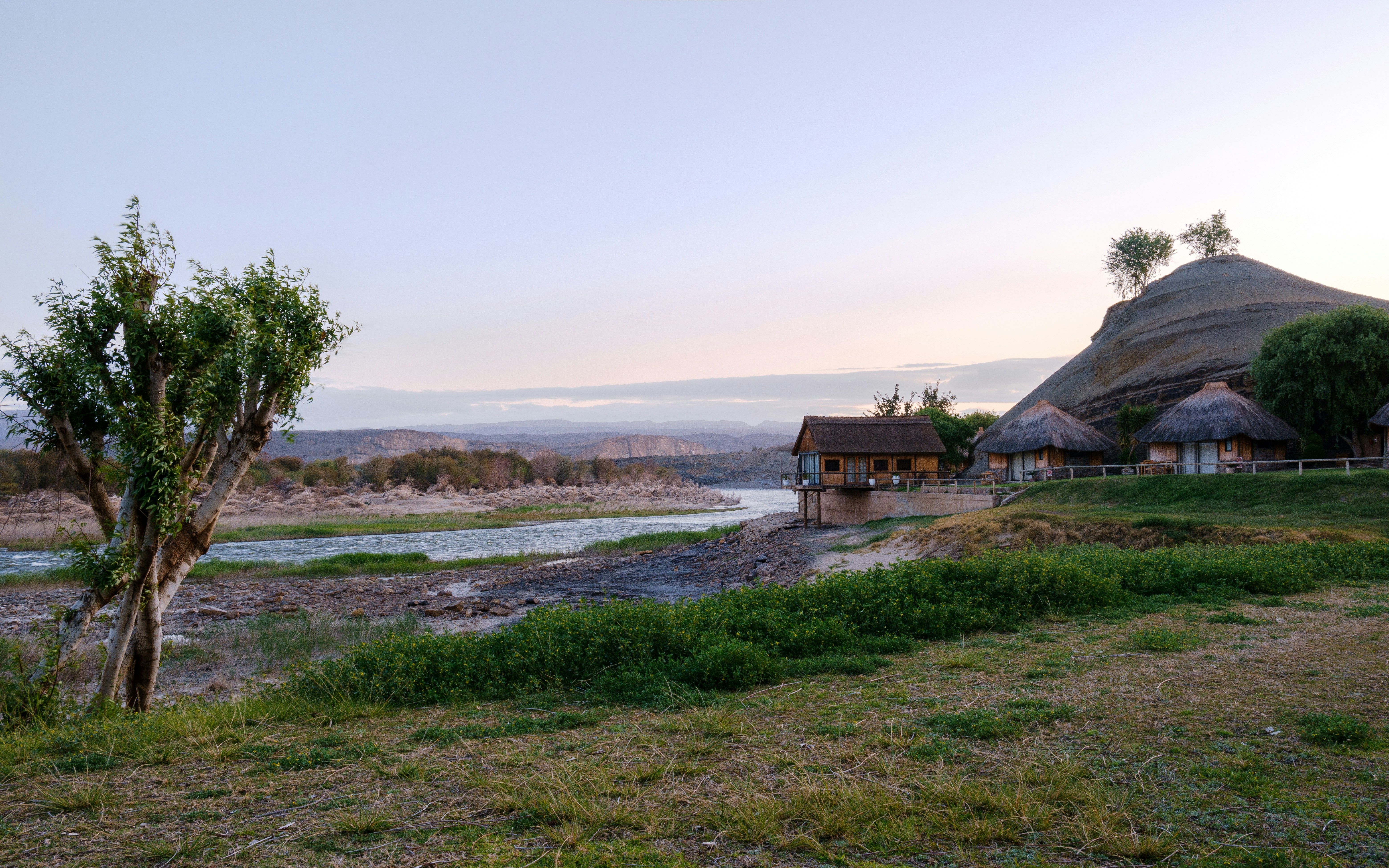 a few houses by a river, a lodge at the oranje river in Namibia