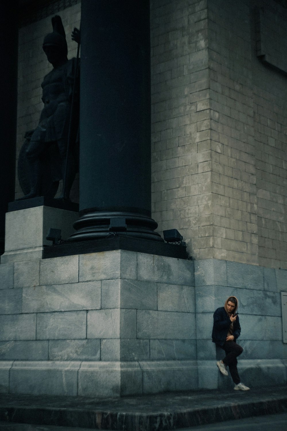 a person standing next to a statue