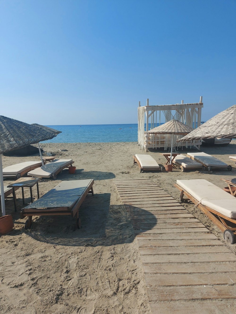 a beach with tables and chairs