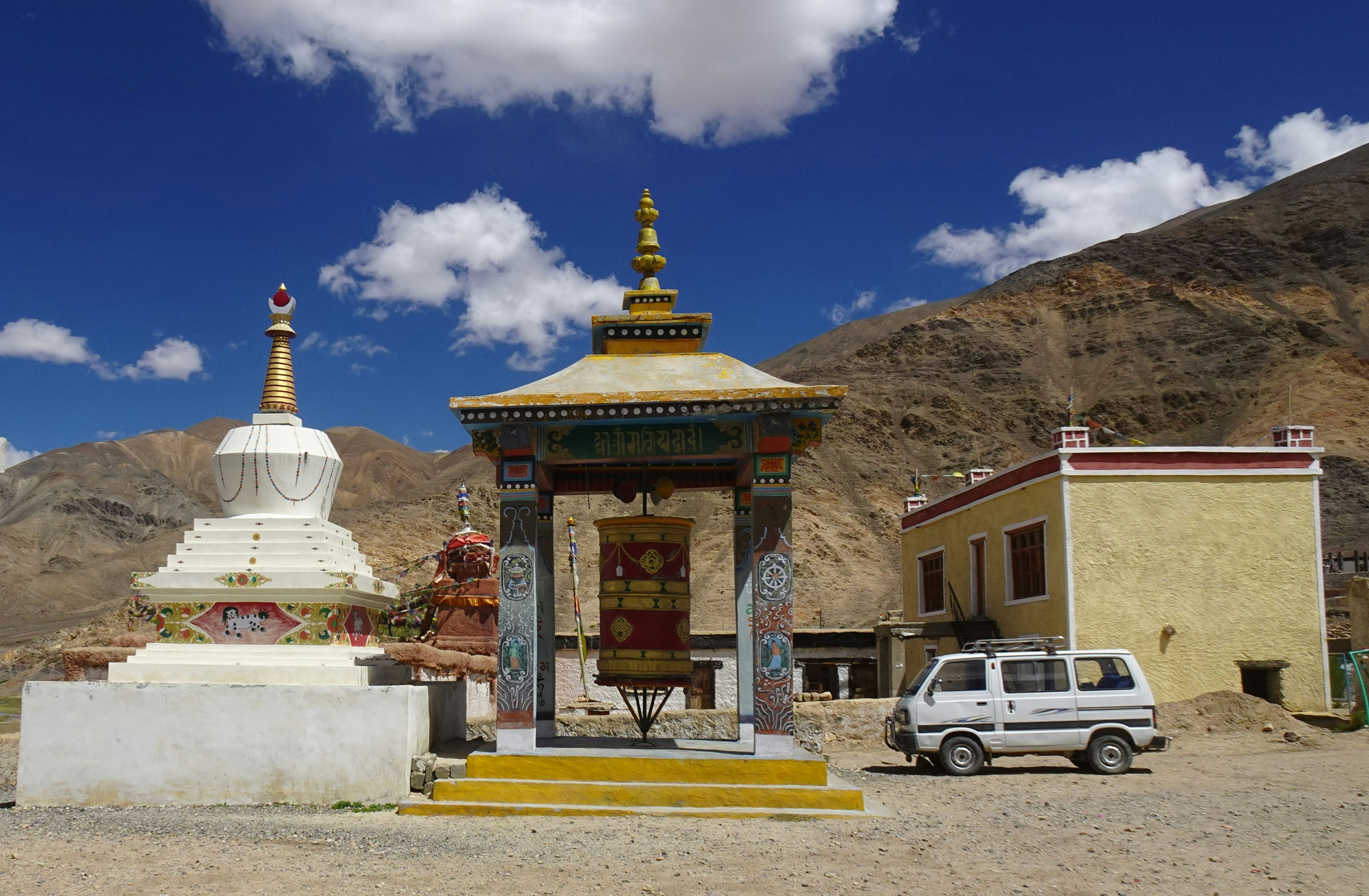 a car parked in front of a building with a gold roof