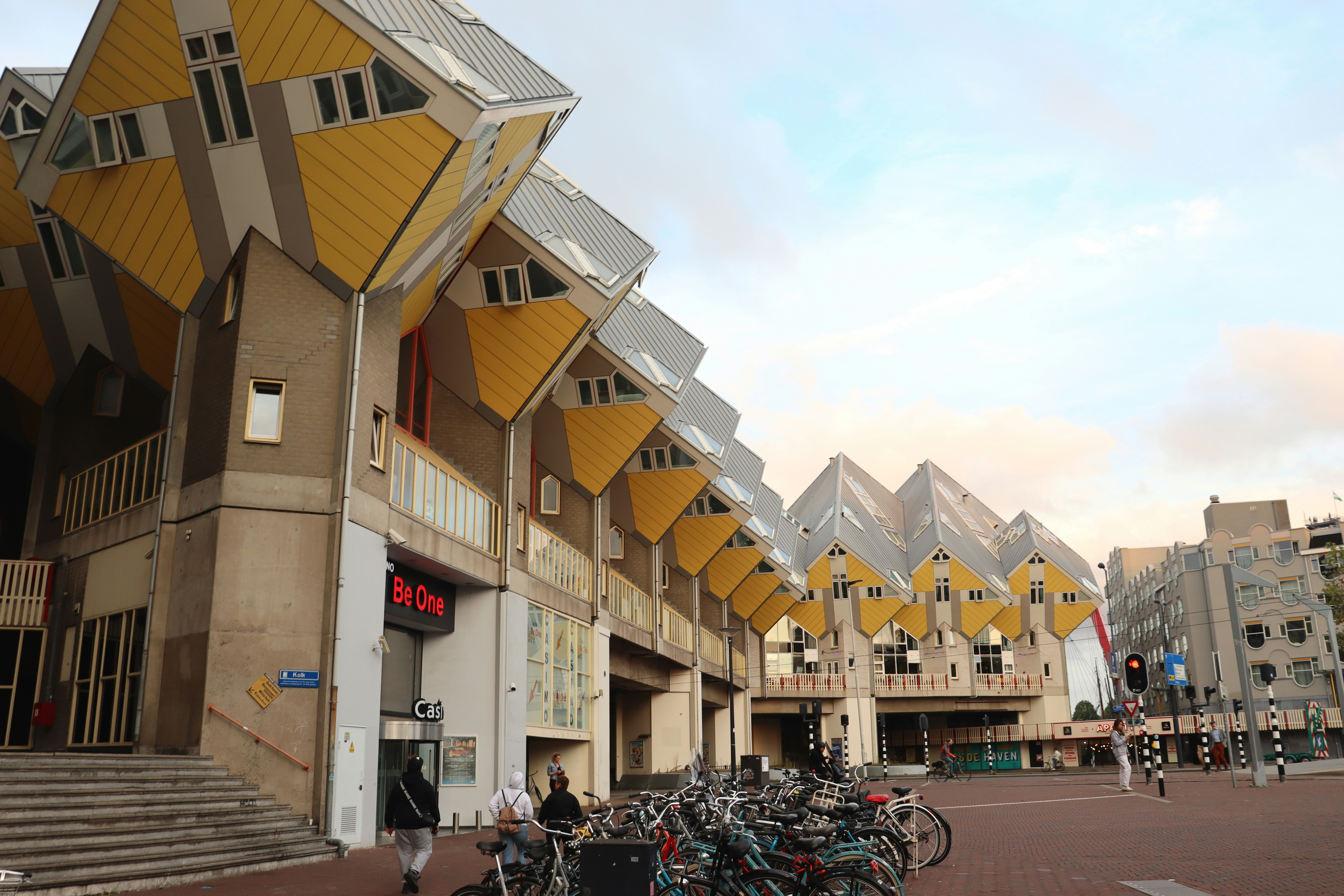 a group of people walking around a city, Cube Houses in Rotterdam