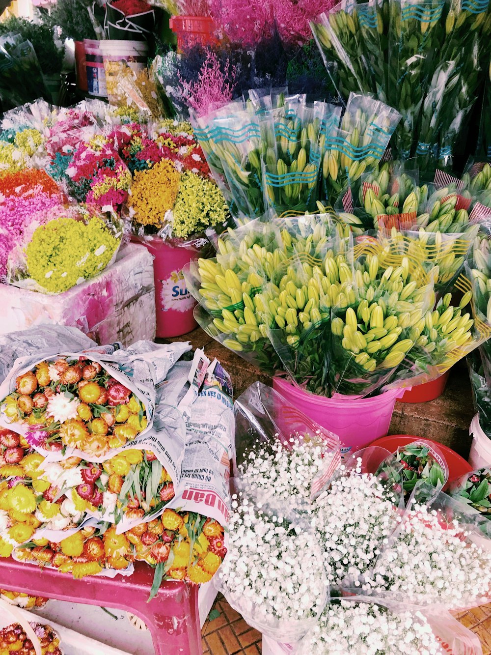 a group of buckets full of flowers