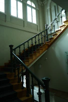 Elegant staircase with dark wood handrails and soft natural light.