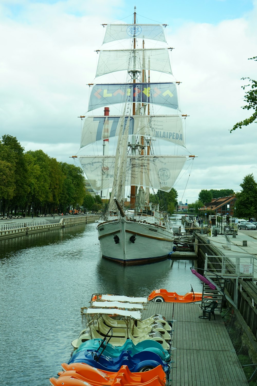 a large sailboat docked at a pier