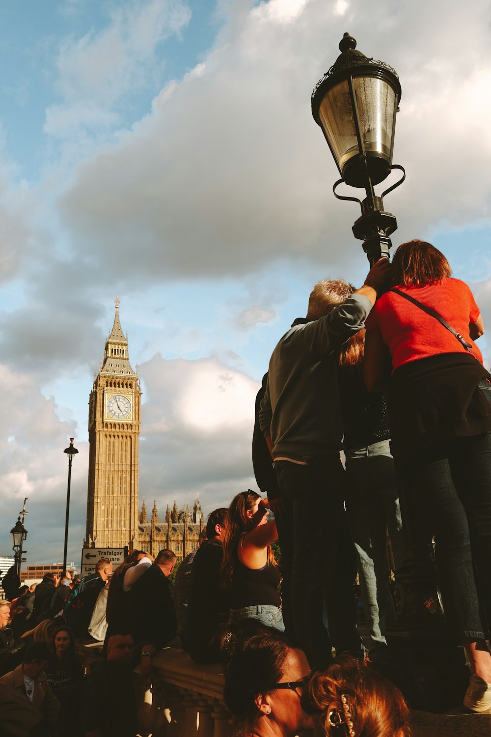 a group of people standing in front of a clock tower