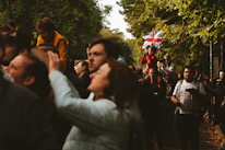 Close-up of diverse families happily gathered around a Union Jack-themed picnic.