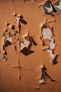 a close-up of a cracking paint due to water damage