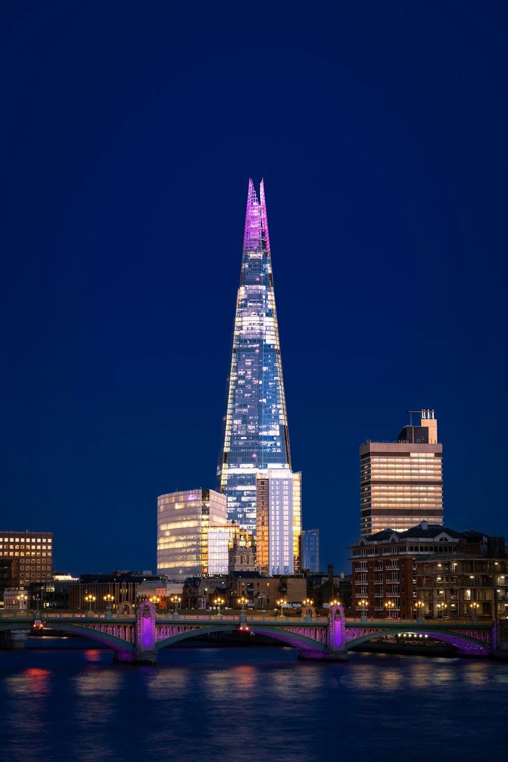 a tall building with lights at night