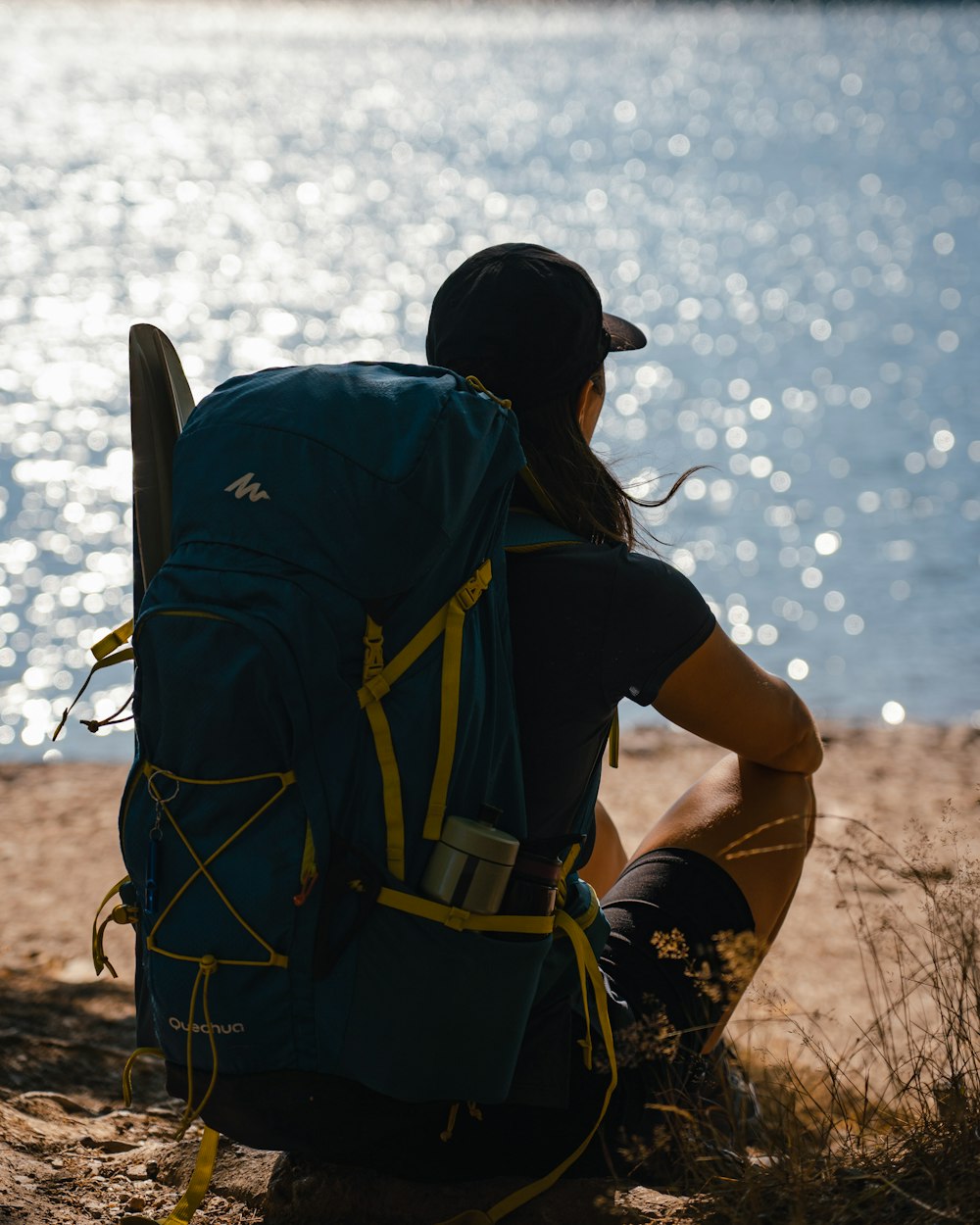 a person wearing a life jacket and sitting on a rock