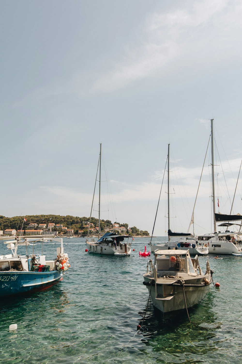 a group of boats sit in a harbor