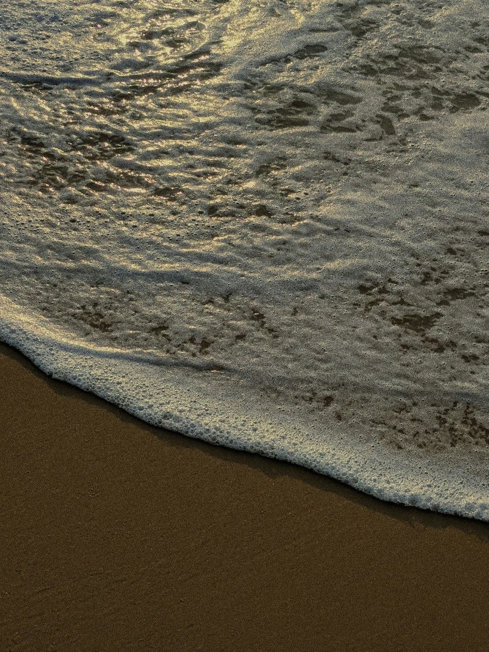 a sandy beach with waves