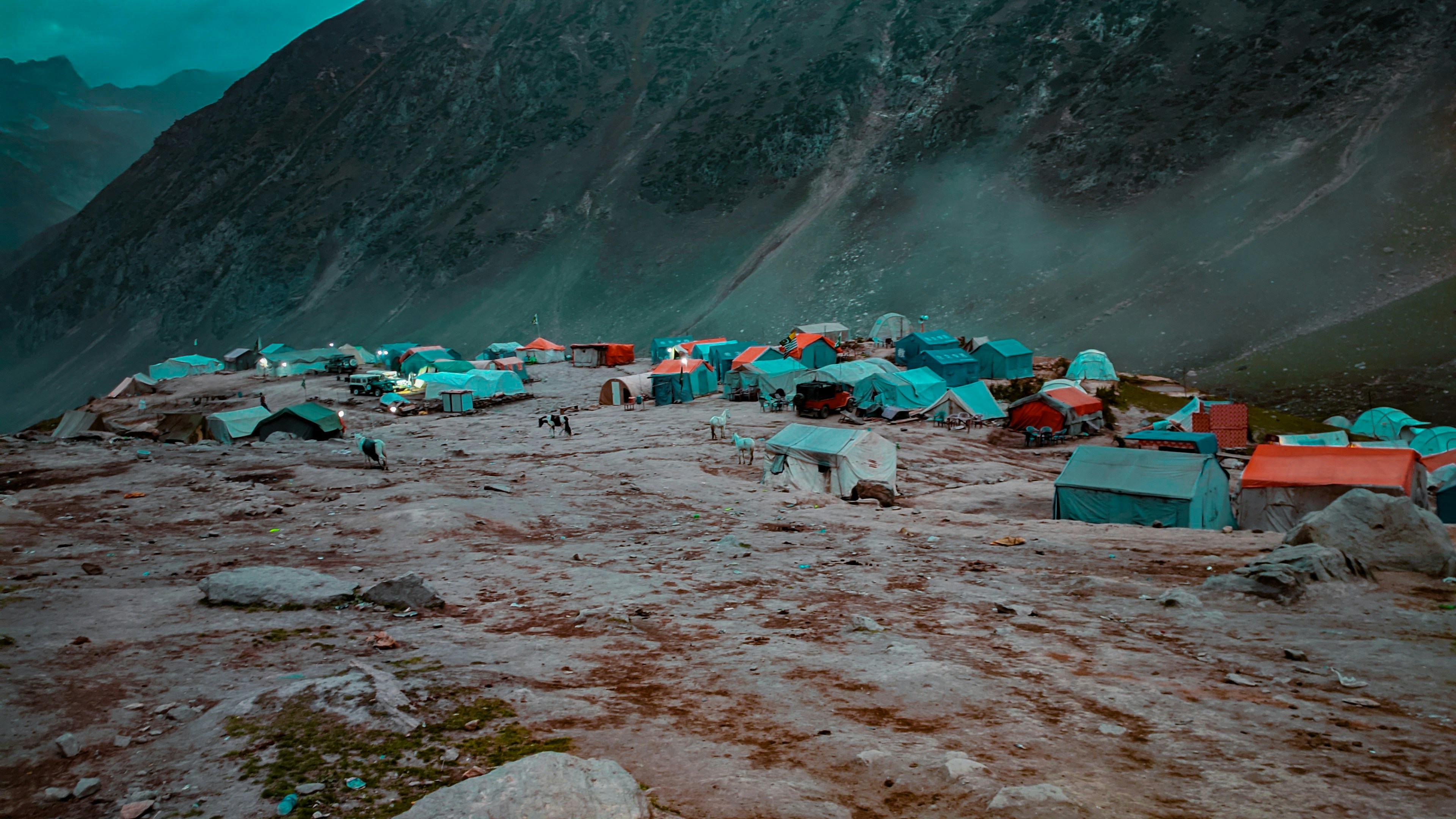 a group of tents on a rocky beach