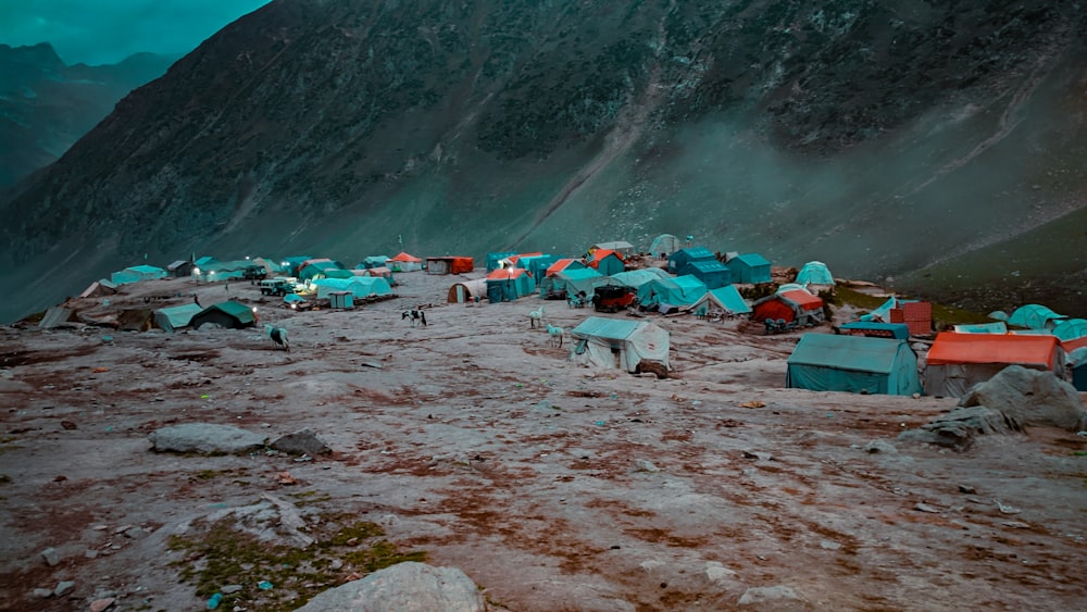 a group of tents on a rocky beach