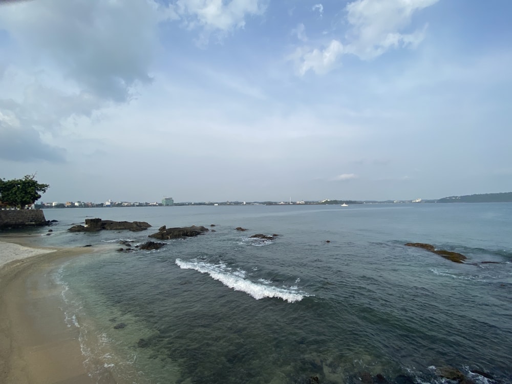 a beach with rocks and a body of water