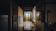 A bright hallway leading to various viewing rooms designed for student activities.