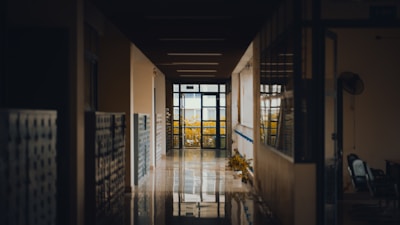 Small image of hostel hallway with lockers and bright overhead lights.